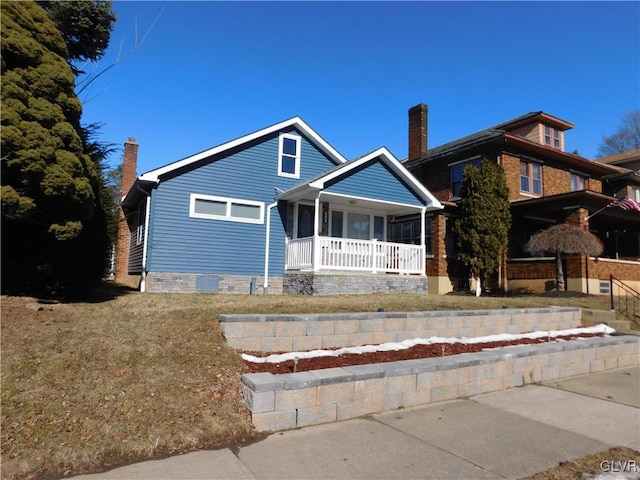 view of front of home featuring covered porch and a front yard