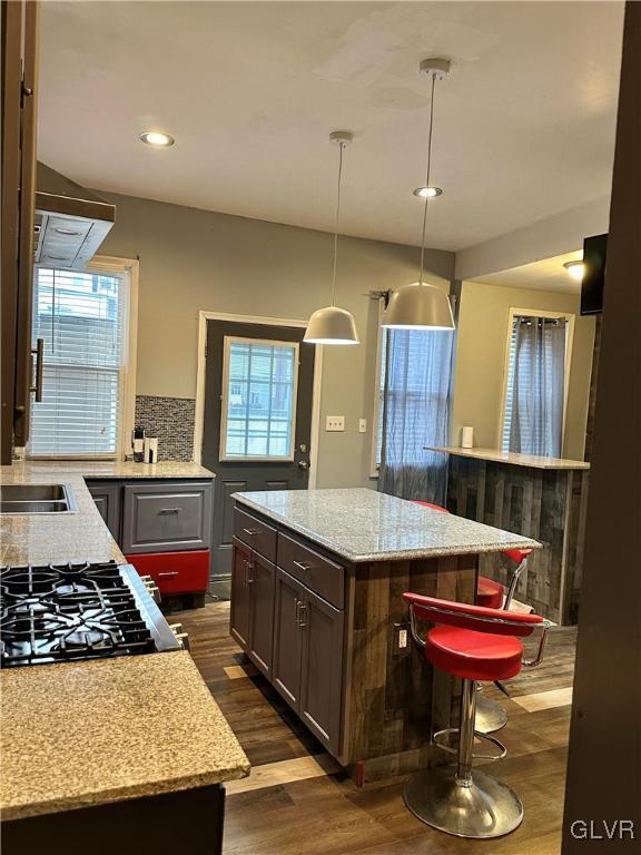 38 12th St, Allentown City, PA 18101 - kitchen featuring dark wood-type flooring, a breakfast bar, range hood, recessed lighting, and a center island