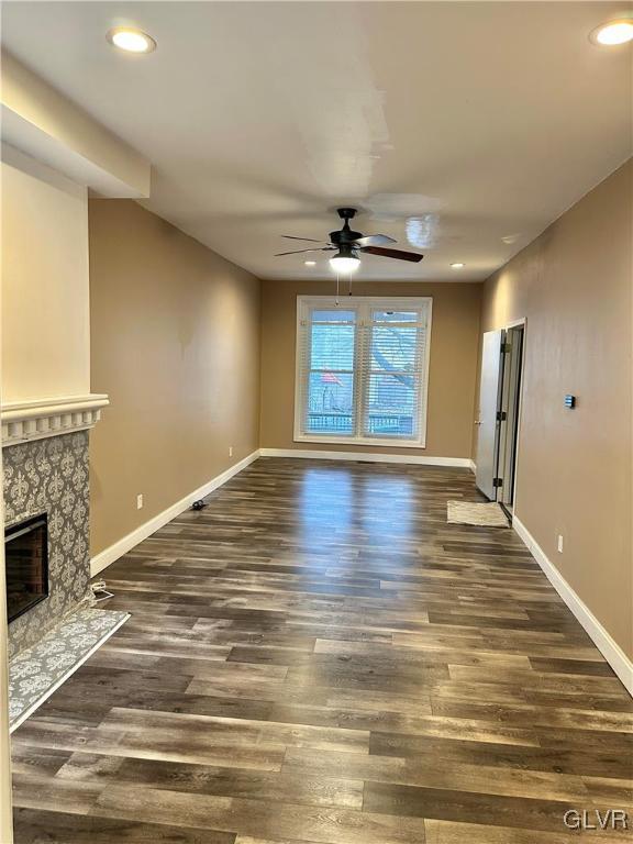38 12th St, Allentown City, PA 18101 - unfurnished living room featuring ceiling fan, wood finished floors, recessed lighting, a high end fireplace, and baseboards