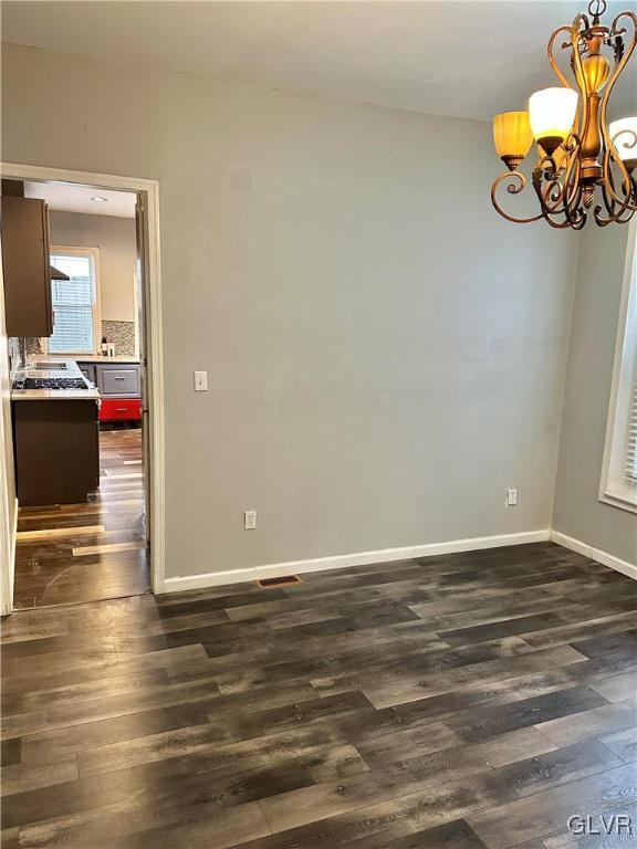 38 12th St, Allentown City, PA 18101 - unfurnished room with a chandelier, dark wood-style floors, and baseboards