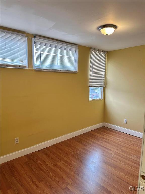 38 12th St, Allentown City, PA 18101 - spare room with baseboards and wood finished floors