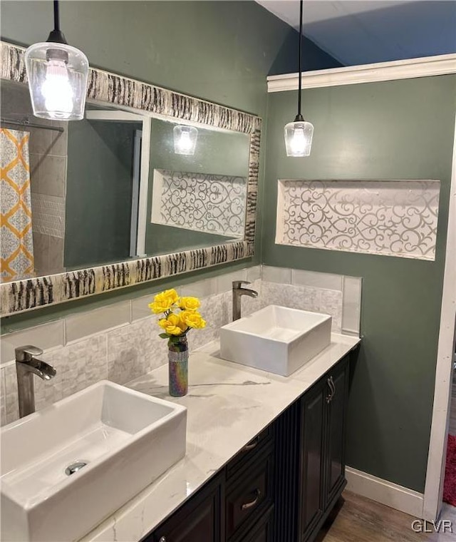 38 12th St, Allentown City, PA 18101 - full bath with double vanity, wood finished floors, baseboards, tasteful backsplash, and vaulted ceiling