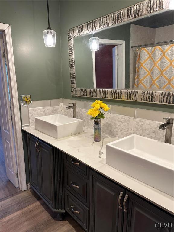 38 12th St, Allentown City, PA 18101 - bathroom with double vanity, wood finished floors, and a shower with shower curtain