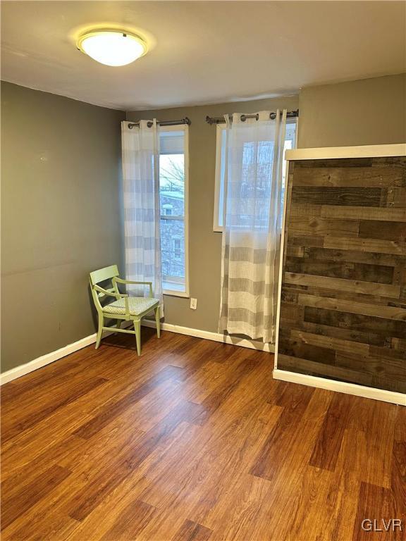 38 12th St, Allentown City, PA 18101 - living area featuring healthy amount of natural light, wood finished floors, and baseboards