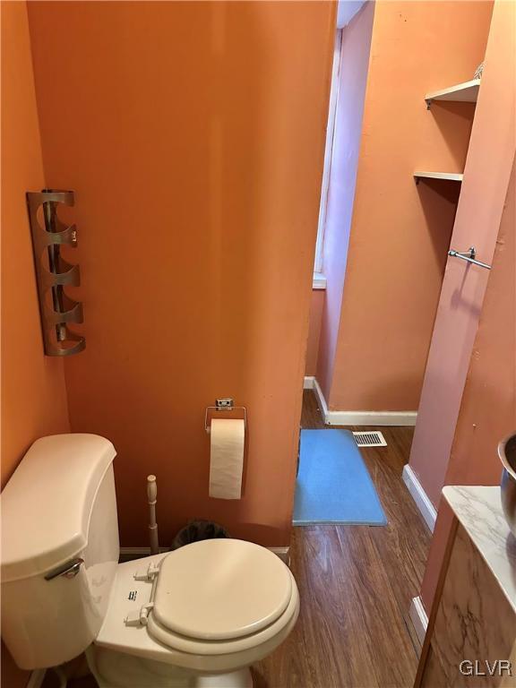 38 12th St, Allentown City, PA 18101 - half bath featuring toilet, wood finished floors, and baseboards
