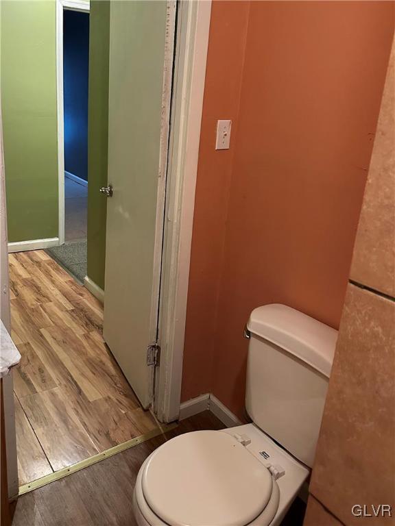 38 12th St, Allentown City, PA 18101 - bathroom with toilet, wood finished floors, and baseboards