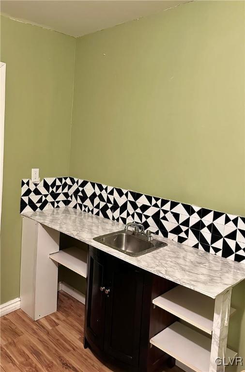 38 12th St, Allentown City, PA 18101 - bar area with a sink, light wood finished floors, and backsplash