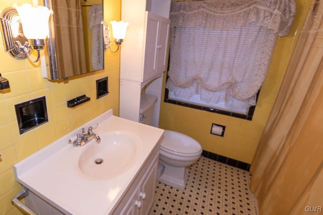 bathroom featuring vanity, tile walls, curtained shower, and toilet