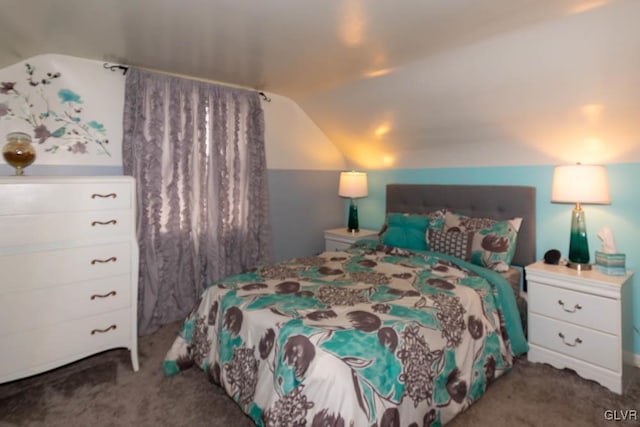 bedroom with lofted ceiling and dark colored carpet