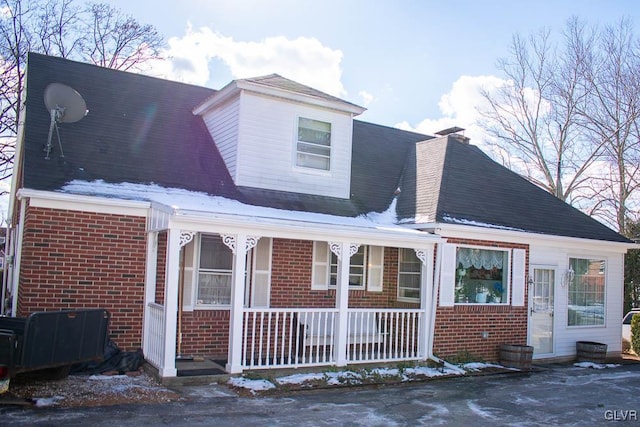 rear view of house featuring a porch