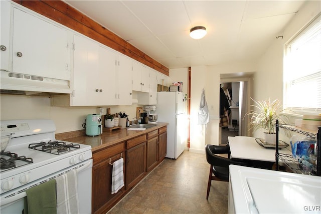 kitchen with white cabinetry, sink, and white appliances