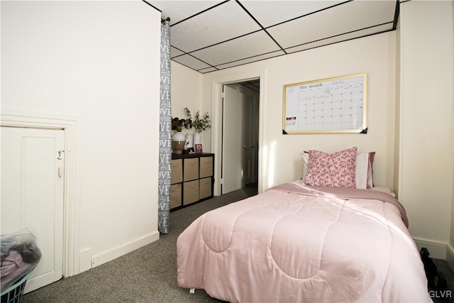 carpeted bedroom with a paneled ceiling