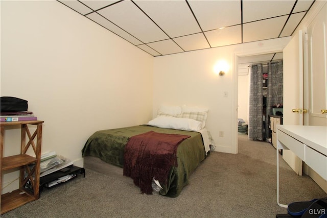 carpeted bedroom with a drop ceiling