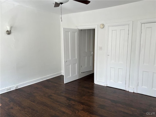 empty room featuring dark wood-type flooring and ceiling fan