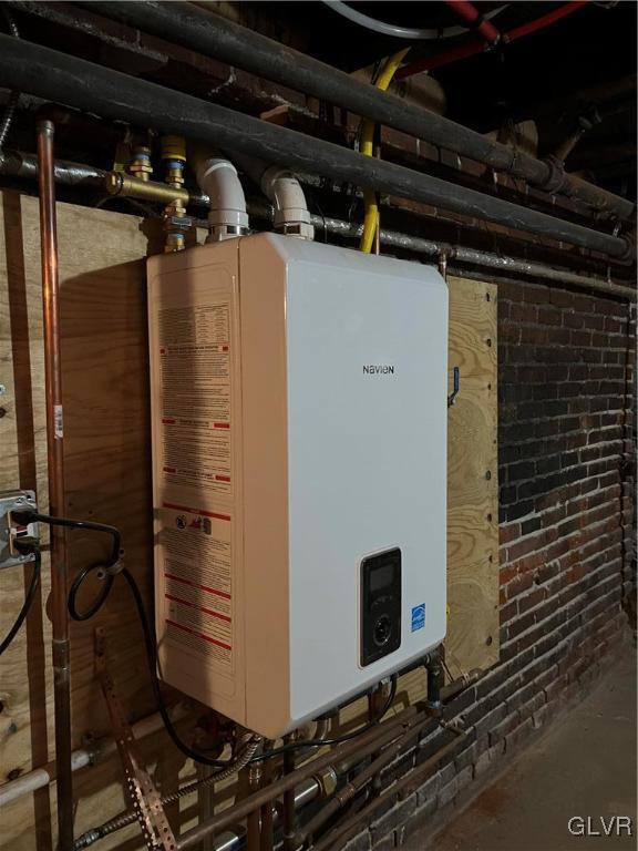 utility room featuring tankless water heater