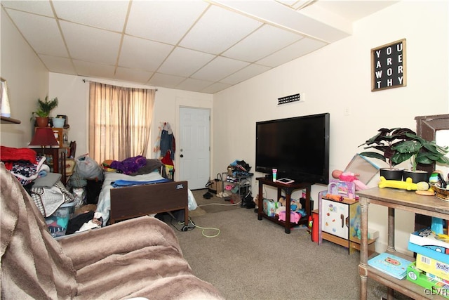 living room with a paneled ceiling and carpet floors