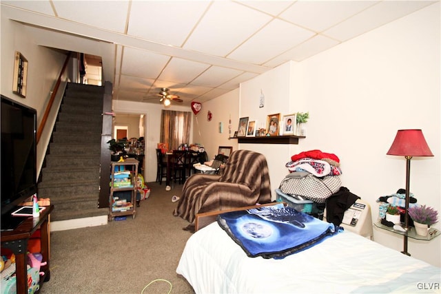 bedroom with a paneled ceiling and carpet flooring