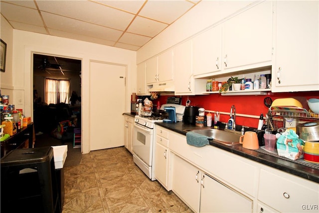 kitchen with white cabinetry, sink, a paneled ceiling, and gas range gas stove