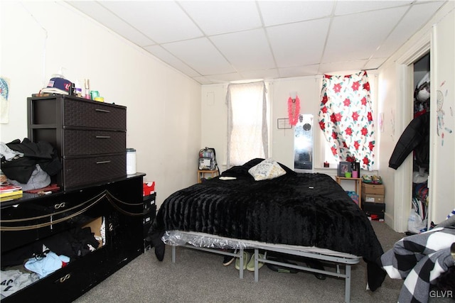 carpeted bedroom with a drop ceiling