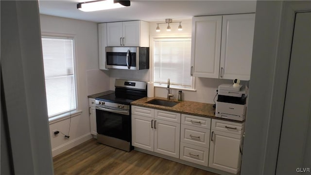 kitchen featuring stainless steel appliances, sink, dark wood-type flooring, and white cabinets