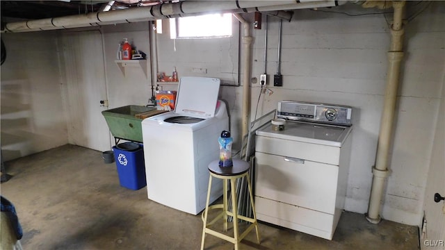 laundry room featuring washing machine and clothes dryer and sink