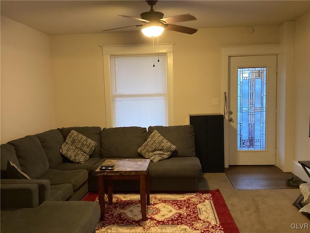 carpeted living room with plenty of natural light and ceiling fan