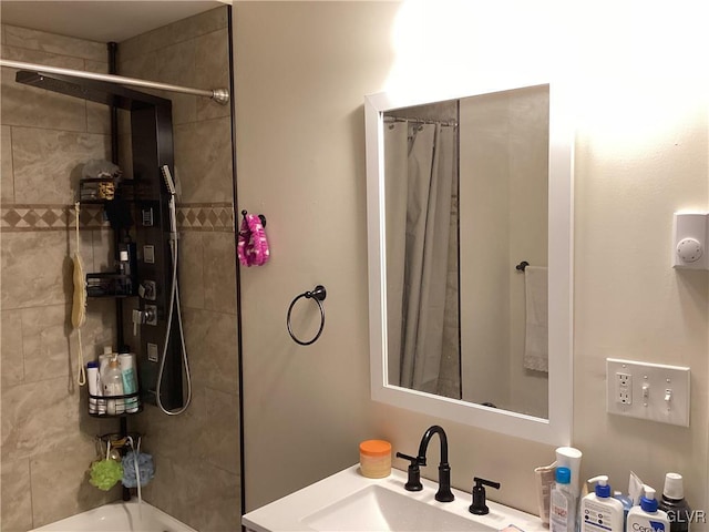 bathroom with shower / bathtub combination with curtain and sink