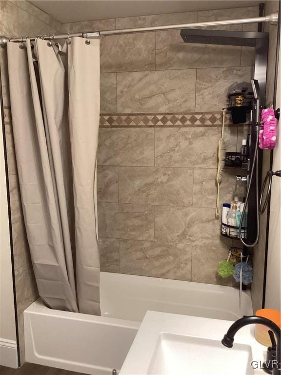 bathroom with sink and shower / bath combo with shower curtain