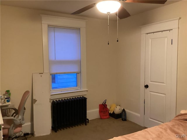 bedroom with ceiling fan and radiator