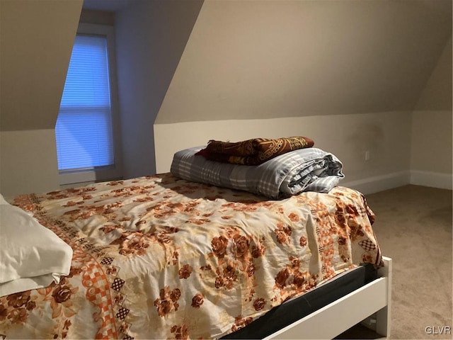 bedroom with vaulted ceiling and carpet