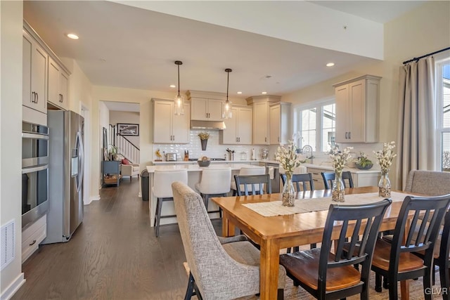 dining room with dark hardwood / wood-style flooring