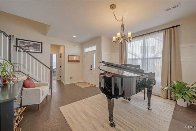 interior space featuring an inviting chandelier and hardwood / wood-style floors