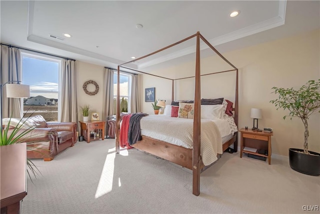 bedroom featuring light carpet, crown molding, and a raised ceiling