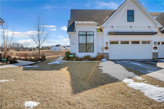 view of front of property featuring a garage and a front lawn