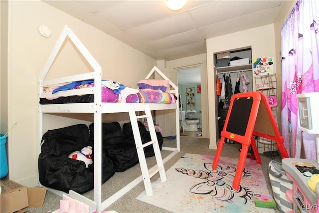 bedroom with carpet flooring and a paneled ceiling