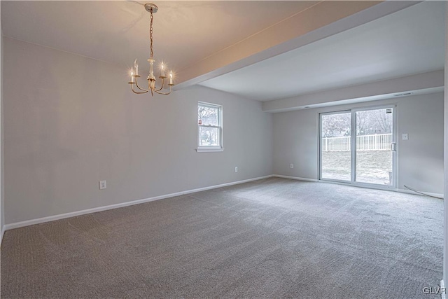 spare room featuring beamed ceiling, carpet floors, and a notable chandelier