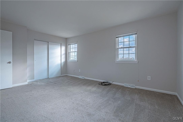 unfurnished bedroom featuring carpet floors and a closet