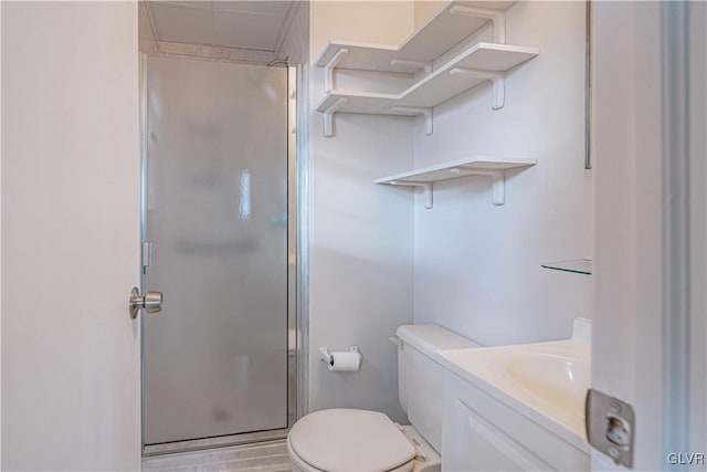 bathroom featuring hardwood / wood-style flooring, walk in shower, vanity, and toilet