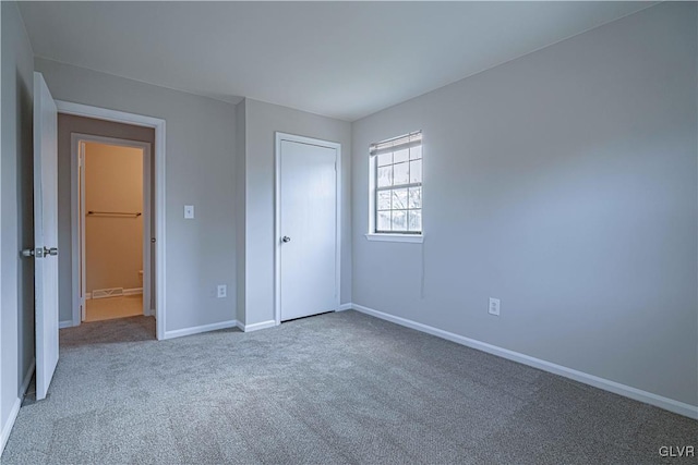 unfurnished bedroom featuring a closet and carpet