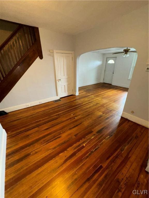 unfurnished living room featuring hardwood / wood-style flooring and ceiling fan