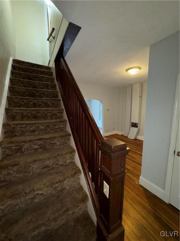 staircase featuring hardwood / wood-style floors