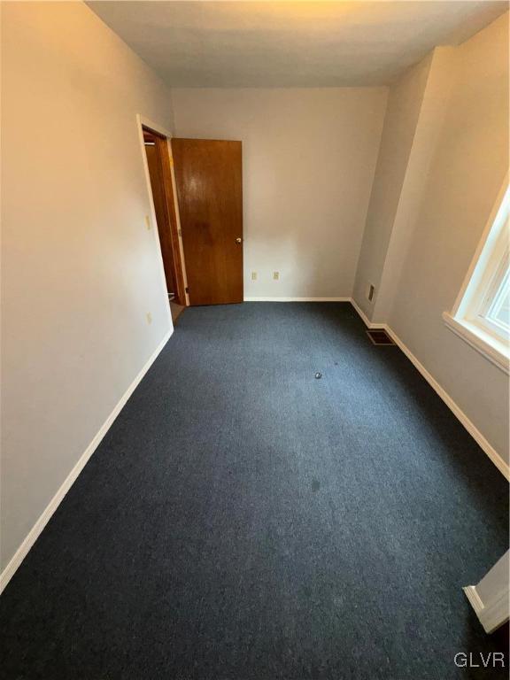 empty room with carpet flooring