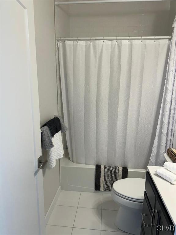 full bathroom with toilet, vanity, shower / bathtub combination with curtain, and tile patterned flooring