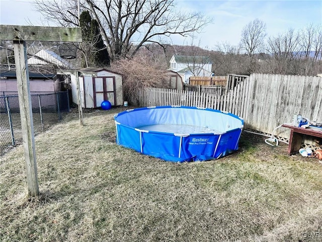 view of yard with an empty pool and a shed