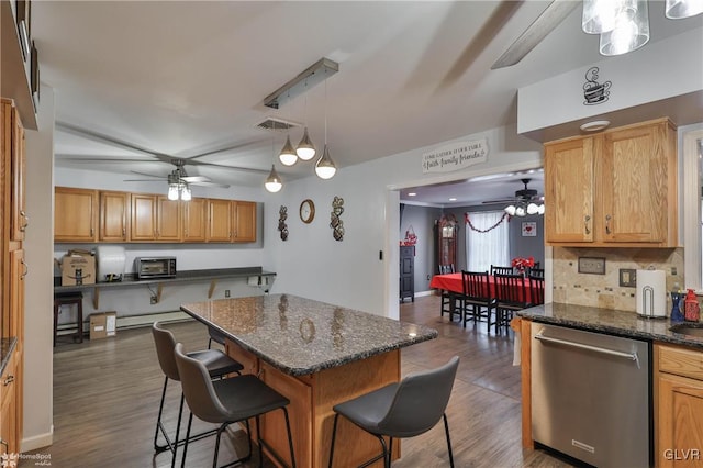 kitchen featuring dishwasher, a kitchen breakfast bar, decorative backsplash, hanging light fixtures, and dark wood-type flooring