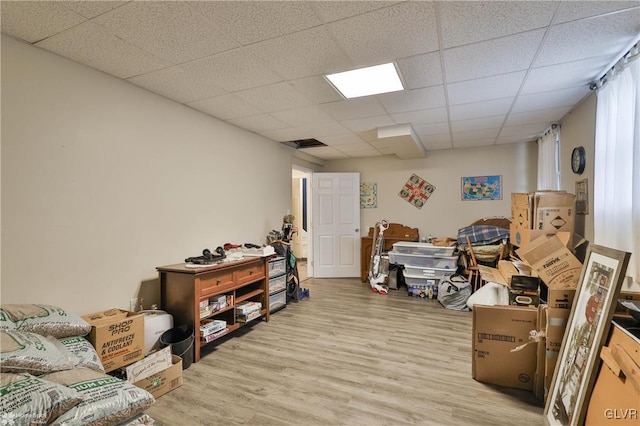 interior space with light hardwood / wood-style flooring and a drop ceiling