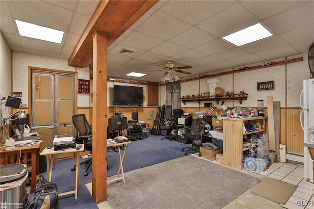 misc room featuring a drop ceiling, a baseboard heating unit, and ceiling fan