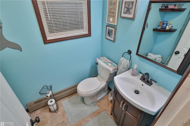 bathroom featuring vanity, baseboard heating, and toilet