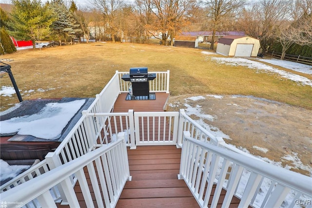 yard covered in snow with a wooden deck and a storage shed