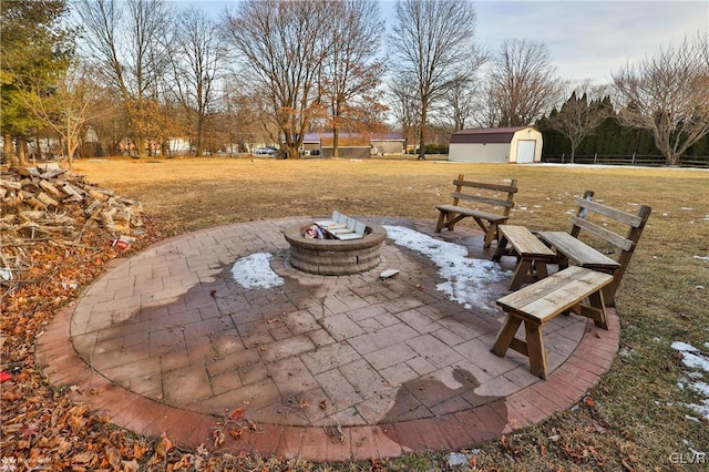 view of patio with a storage unit and a fire pit